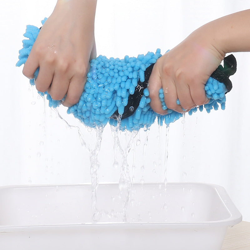 Wringing water out of the Coathaus chenille pet drying towel to show how absorbent it is