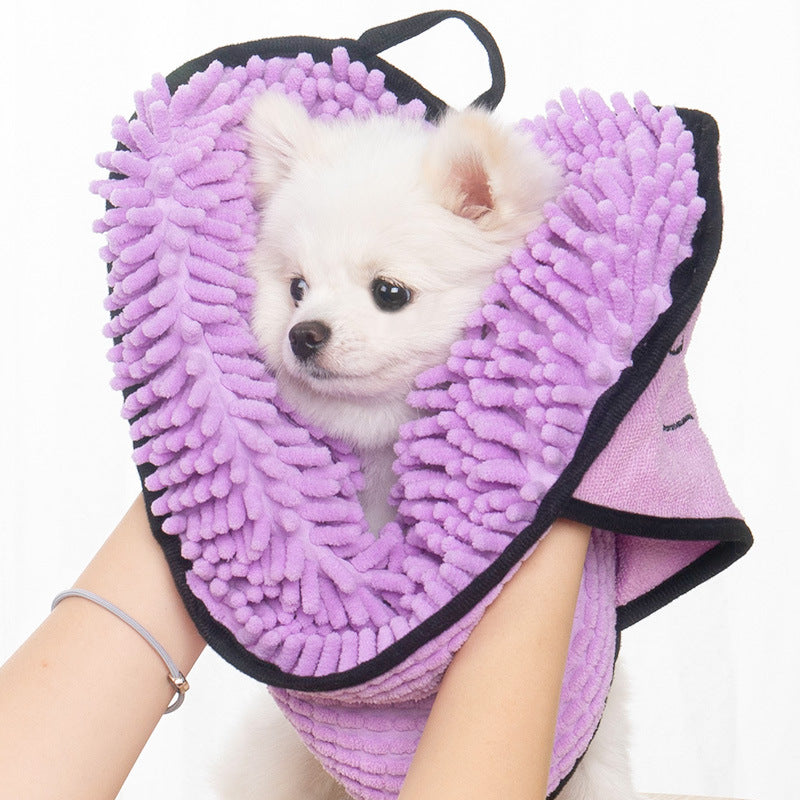 A small dog wrapped in the lavender Coathaus Microfiber Pet Drying Towel