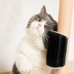 Cat grooming itself against the Coathaus corner brush wrapped around a table leg