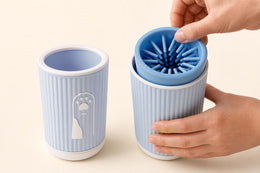 The silicone insert lifting out of the Coathaus Paw Cleaner Cup for rinsing