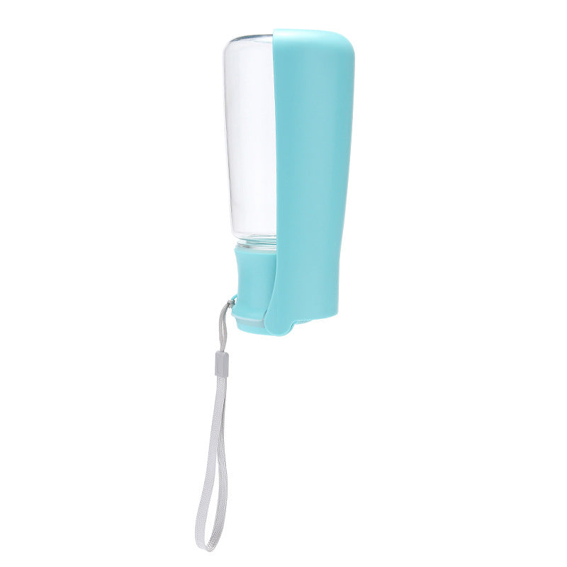 Teal Coathaus travel water bottle folded closed with the wrist strap, showing how flat it packs down
