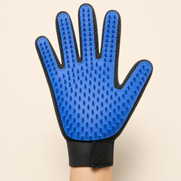 Hand wearing the Coathaus grooming glove, palm facing forward showing the long silicone pins